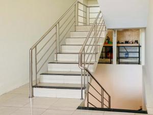 a staircase with metal railings in a house at RedDoorz near Lippo Mall Yogyakarta in Demangan