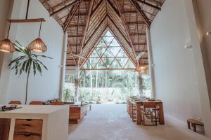 a large room with a large window and tables and chairs at SEACLUB Siargao in General Luna