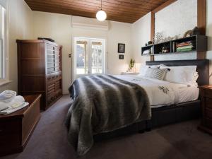 a bedroom with a large bed and a dresser at Ashling in Hepburn Springs