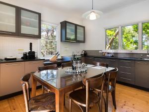 a kitchen with a dining room table and chairs at Ashling in Hepburn Springs