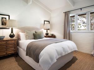 a bedroom with a bed and two lamps and a window at Paul Bangay The Farmhouse in Denver
