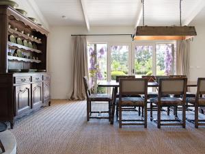 a dining room with a table and chairs at Paul Bangay The Farmhouse in Denver