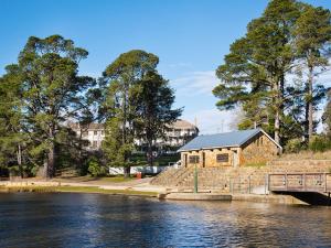 a building next to a body of water with a bridge at Lake Daylesford Apartments 2A in Daylesford
