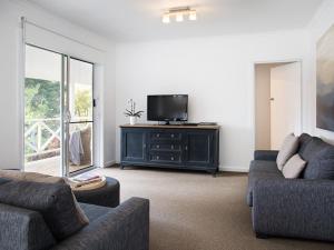 a living room with two couches and a flat screen tv at Lake Daylesford Apartment 6 in Daylesford