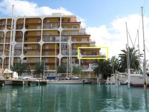 a large building on the water next to a marina at Apartamento Bahia III in Empuriabrava