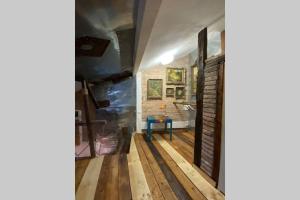 a hallway with wood flooring and a brick wall at The House a la Cluj in Cluj-Napoca