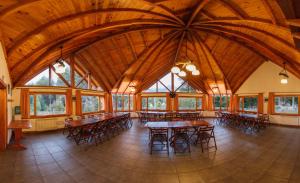 a large room with tables and chairs in a building at Melewe in Villa La Angostura
