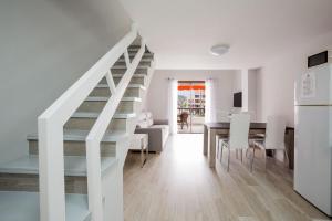 a kitchen and dining room with a staircase in a house at Parque Santiago II, Las Américas in Playa de las Americas