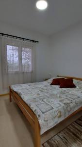 a bedroom with a large bed in a room at Apartmani Neven in Irig