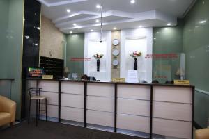 a counter in a room with clocks on the wall at Hotel Zabaykalie in Chita