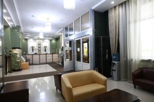 a lobby of a store with a chair and a table at Hotel Zabaykalie in Chita