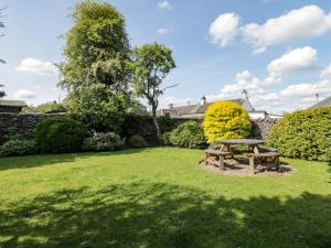 a picnic table in the garden of a house at Riven Oak in Kendal