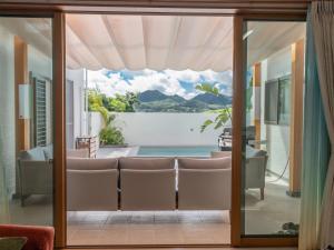 a room with a view of the ocean from a house at 美ら海ビレッジ プール＆テラス in Motobu