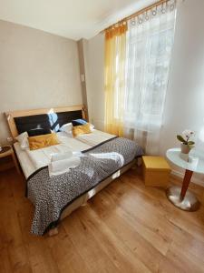 a bedroom with a bed and a window at Dworek Zakopane in Zakopane