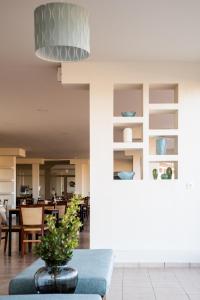 a living room with a couch and a table at Chrissy's Paradise in Agia Pelagia