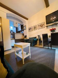 a living room with a table and a living room at Apartment Styria Lent in Maribor