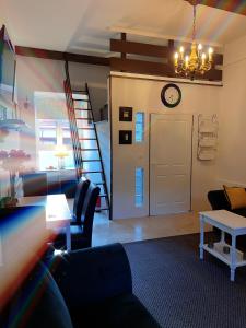 a living room with a couch and a clock on the wall at Apartment Styria Lent in Maribor