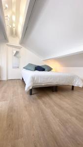 a bedroom with a large bed in a white room at T2 Confort Sillon St Malo in Saint Malo