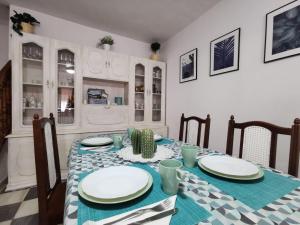 a dining room table with a blue and white table cloth at Casa de la Parra in Bédar
