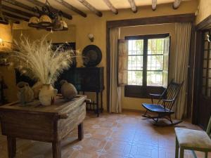 a living room with a table and chairs and a window at Cortijo rural Archidona in Archidona