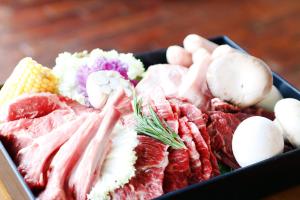 a tray of different types of meat and vegetables at Holiday Inn & Suites Alpensia Pyeongchang Suites, an IHG Hotel in Pyeongchang 