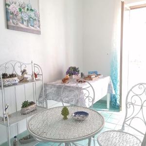 a room with a table and two chairs and a table at B&B Orizzonte Blu in Maratea +31 photos