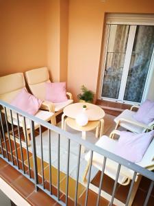 a balcony with two chairs and a table at Tirwal Suite Judería in Teruel