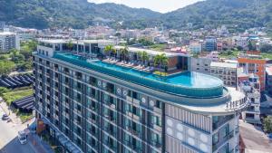 a building with a swimming pool on top of it at The Marina Phuket Hotel in Patong Beach