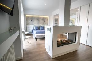 a living room with a fireplace and a bed at Hotel Castellote in Castellote