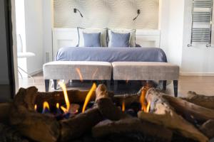 a bedroom with a bed and a fire in front of a fireplace at Hotel Castellote in Castellote