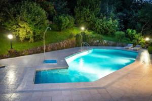 a swimming pool in a backyard at night at Casa Rural Oroimena in Andoain