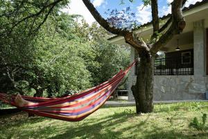 a hammock hanging from a tree in front of a house at Casa Rural Oroimena in Andoain