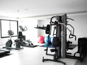 a gym with several tread machines in a room at The Marina Phuket Hotel in Patong Beach