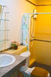 a bathroom with a shower and a toilet and a sink at Blue House Sukhothai in Sukhothai