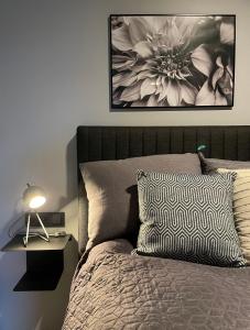 a bedroom with a bed with a flower picture on the wall at Arctic Loft Apartments in Akureyri