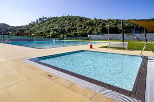 a large swimming pool in a building at CASA NÚRIA con Piscina pública y solarium in Bescanó