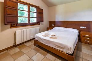 Posteľ alebo postele v izbe v ubytovaní Mas Aimà Casa rural en la Garrotxa + 25 fotografií