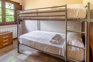 Posteľ alebo postele v izbe v ubytovaní Mas Aimà Casa rural en la Garrotxa
