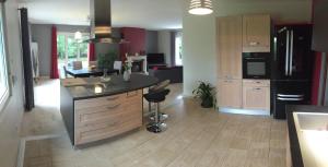 a kitchen with a island in the middle of a room at Maison calme avec grand jardin en Sologne in Chaumont-sur-Tharonne