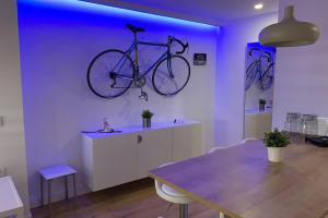a bike hanging on a wall in a room with a table at MAMI / Apto 5 in San Sebastián de la Gomera