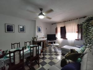 a living room with a couch and a table at Casa de la Parra in Bédar