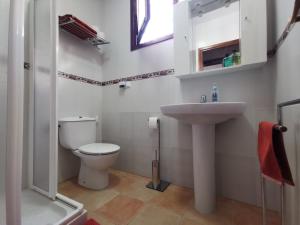 a bathroom with a toilet and a sink at Casa de la Parra in Bédar +7 photos