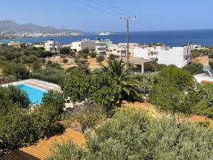 a villa with a pool and a view of the ocean at Katerina Charming Place in Agios Nikolaos