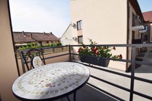 a white table and chairs on a balcony at Luxury Apartment Central in Târgu-Mureş