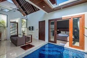 an indoor pool in a villa with a bedroom at PANDAWA VILLAS SEMINYAK in Seminyak