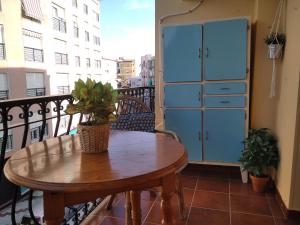 uma varanda com uma mesa de madeira e armários azuis em Apartamento Esperanza El Palo - 112 m2 - 3 bedrooms - centrally located em Málaga