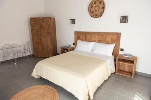 a bedroom with a large bed and two night stands at Albergo Rurale Casa Fois in Valledoria