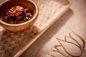 a small wooden bowl of food on a table at Kfar Maccabiah Business & Sport Hotel in Ramat Gan