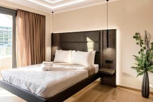Postel nebo postele na pokoji v ubytování Megusta Suites