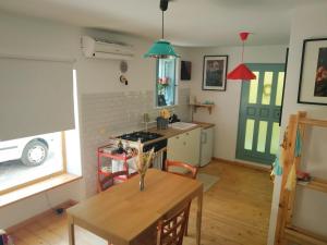 a kitchen with a table and a stove top oven at La finestra sul cortile in Atri